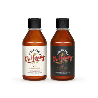 Two bottles of 'Oh Honey' picante sauce on a white background